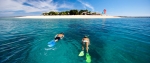 Snorkel through colourful coral reefs